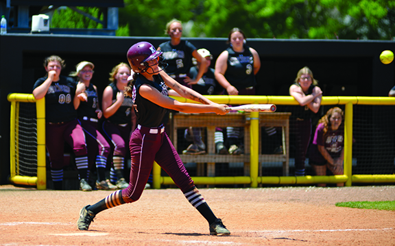 Gracie Williams hits the game-winning single at the USM softball complex as her teammates anxiously look on. Sam Fioretti / The Star-Herald