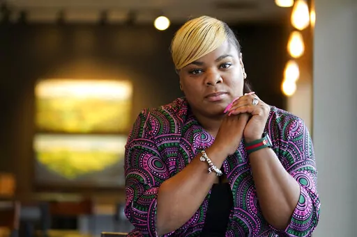 Tanita Hilliard sits for a portrait on Oct. 25, 2022, in Memphis, Tenn. When a young man live streamed himself driving around Memphis and shooting at people, she recognized the man as Ezekiel Kelly, one of her former middle school students. Kelly is accused of killing three people and injuring three others. (AP Photo/Mark Humphrey)