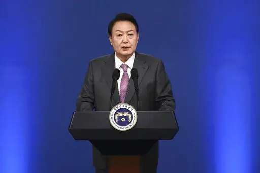 South Korean President Yoon Suk Yeol delivers a speech during a news conference to mark his first 100 days in office at the presidential office in Seoul, South Korea, Wednesday, Aug. 17, 2022. (Chung Sung-Jun/Pool Photo via AP)
