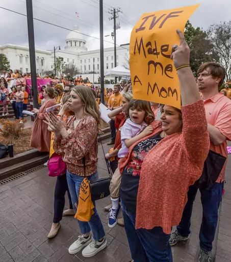 Veronica Wehby-Upchurch a sign and son Ladner Upchurch as hundreds gather for a protest rally for in vitro fertilization legislation Wednesday, Feb. 28, 2024, in Montgomery, Ala. The Alabama Supreme Court ruled, Friday, Feb. 16, 2024, that frozen embryos can be considered children under state law, a ruling critics said could have sweeping implications for fertility treatments. (Mickey Welsh/The Montgomery Advertiser via AP)