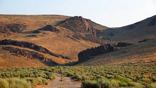 The Montana Mountains loom over Thacker Pass in northern Nevada on July 14, 2021. The new lithium mining project closest to development is the one proposed for Thacker Pass by Lithium Americas. That northern Nevada mine would make millions of tons of lithium available, but Native American tribes have argued that it's located on sacred lands and should be stopped. (Jason Bean/The Reno Gazette-Journal via AP, File)
