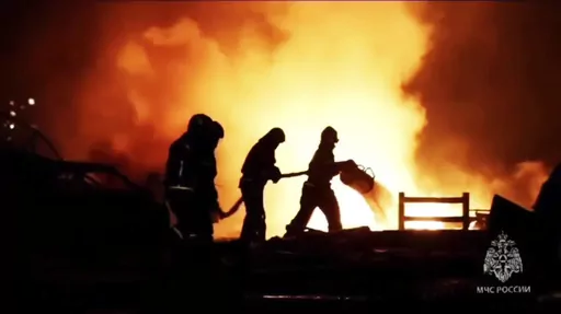 In this image made from video provided by the Russian Emergency Situations Ministry press service, firefighters work to extinguish a fire at a petrol station on a road near Makhachkala, the capital of Dagestan, Russia, late Monday, Aug. 14, 2023. (Ministry of Emergency Situations press service via AP)