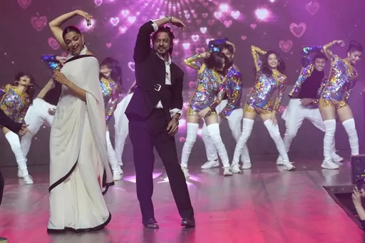 Bollywood actors Deepika Padukone, left, and Shah Rukh Khan, right, dance at an event to celebrate the success of their movie "Jawan" in Mumbai, India, on Sep. 15, 2023. India’s Hindi language movie industry, Bollywood, made an impressive financial recovery in 2023 after a pandemic-driven slowdown, audience fatigue with big studio productions and Bollywood megastars, and streaming platforms taking away a big chunk of viewership. (AP Photo/Rajanish Kakade, File)