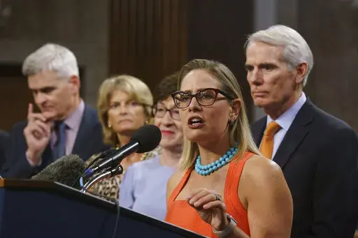 Sen. Kyrsten Sinema, D-Ariz., center, joined from left by, Sen. Bill Cassidy, R-La., Sen. Lisa Murkowski, R-Alaska, Sen. Susan Collins, R-Maine, and Sen. Rob Portman, R-Ohio, speak to reporters just after a vote to start work on a nearly $1 trillion bipartisan infrastructure package, at the Capitol in Washington, July 28, 2021. Sinema received a $1 million surge of campaign cash over the past year from private equity professionals, hedge funds and venture capitalists whose interests she has stau