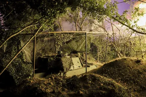 In this photo provided by Ukraine's 24th Mechanised Brigade press service, servicemen of the 24th Mechanised Brigade fire 155mm M-109 "Paladin" howitzer towards Russian forces near the frontline town of Chasiv Yar, Donetsk region, Ukraine, Saturday, July 20, 2024. (Oleg Petrasiuk/Ukrainian 24th Mechanised Brigade via AP)