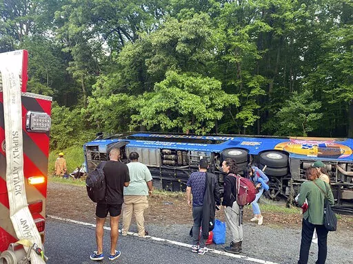 This image provided by the Baltimore County Fire Department shows the scene of a Megabus crash on I-95 south near Kingsville, Md., Sunday, May 22, 2022. The vehicle was carrying 47 people. Officials said that 15 of the 27 people injured were taken to local hospitals. (Baltimore County Fire Department via AP)