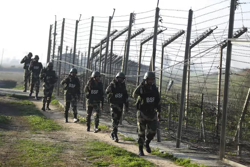 FILE- Indian Border Security Force (BSF) soldiers patrol near the India-Pakistan border fencing at Suchet Garh in Ranbir Singh Pura, Jammu and Kashmir, India, Jan. 23, 2020. For decades, India has tried to thwart Pakistan in a protracted dispute over Kashmir. But in the last two years, policy makers in New Delhi have been increasingly turning their focus to Beijing, in a significant shift in India's foreign policy as the nation celebrates 75 years of independence. (AP Photo/Channi Anand, File)