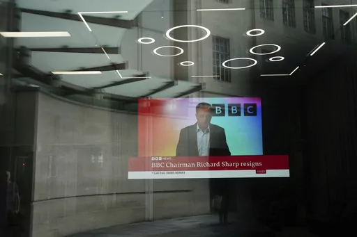 A screen showing a news report through the windows of the BBC, after chairman Richard Sharp announced he was quitting as BBC chairman, in London, Friday April 28, 2023. The chairman of the BBC has resigned after a report found he breached the government rules governing public appointments. The publicly funded national broadcaster has been under pressure after it was revealed that Sharp, a Conservative Party donor helped arrange a loan for then-Prime Minister Boris Johnson in 2021, weeks before h