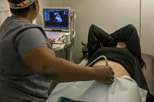 An operating room technician performs an ultrasound on a patient at an abortion clinic in Shreveport, La., Wednesday, July 6, 2022. Serious pregnancy complications are rare in the United States but they still affect thousands of women each year. (AP Photo/Ted Jackson, File)