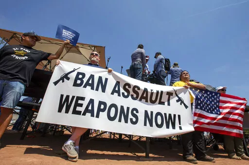 Demonstrators hold a banner to protest the visit of President Donald Trump to the border city after the Aug. 3 mass shooting in El Paso, Texas, on Aug. 7, 2019. A gunman killing multiple elementary school children and adults in Texas on Tuesday, May 24, 2022, adds to the state's grim recent history of mass shootings. (AP Photo/Andres Leighton, File)
