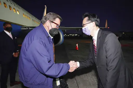 In this photo released by the Taiwan Ministry of Foreign Affairs, from left, U.S. Democratic House members John Garamendi shakes hands with Donald Yu-Tien Hsu, Director-General, dept. of North American Affairs, Taiwan's Ministry of Foreign Affairs after arriving on a U.S. government plane at Songshan airport in Taipei, Taiwan on Sunday, Aug 14, 2022. The delegation of American lawmakers are visiting Taiwan just 12 days after a visit by U.S. House Speaker Nancy Pelosi that angered China. (Taiwan 