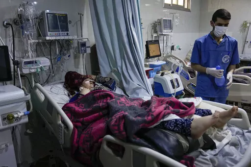 A woman, injured in the earthquake, is treated at the hospital in Bab al-Hawah, Syria, on the border crossing with Turkey, Sunday, Feb. 12, 2023. Six days after a massive earthquake killed thousands in Syria and Turkey, sorrow and disbelief are turning to anger and tension over a sense that there has been an ineffective, unfair and disproportionate response to the historic disaster. (AP Photo/Hussein Malla)