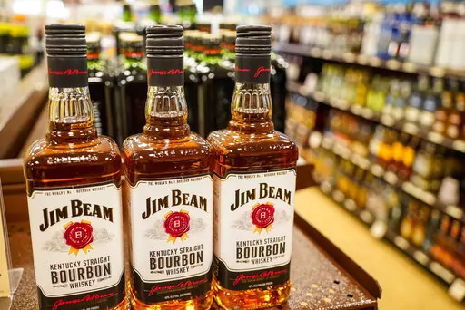 Shelves display bottles of bourbons for sale at a Pennsylvania fine wine and spirits store, Saturday, Jan. 22, 2022, in Harmony, Pa. Jim Beam plans to ramp up bourbon production at its largest Kentucky distillery to meet growing global demand in a more than $400 million expansion to be powered by renewable energy. The project will increase capacity by 50% at the Beam plant in Boston, Kentucky, while reducing greenhouse gas emissions by the same percentage, Beam Suntory said Wednesday, Sept. 14. 