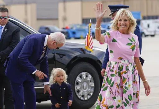President Joe Biden looks at his grandson Beau Biden as first lady Jill Biden waves and walks to board Air Force One at Andrews Air Force Base, Md., Aug. 10, 2022. Jill Biden has tested negative for COVID-19 and will leave South Carolina, where she's been isolated since vacationing with President Joe Biden. Her office says the 71-year-old first lady will rejoin the president at their Delaware beach home later Sunday, Aug. 21, 2022. (AP Photo/Manuel Balce Ceneta, File)