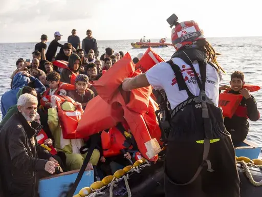 Migrants are rescued from the sea some 30 miles off Libya by the members of the humanitarian ship Geo Barents, Friday, Oct. 6, 2023. Badly advised by relatives and friends, misled by insufficient official information or poor translation services, many can end up in legal limbo for years, cut off from any government aid. (AP Photo/Paolo Santalucia)