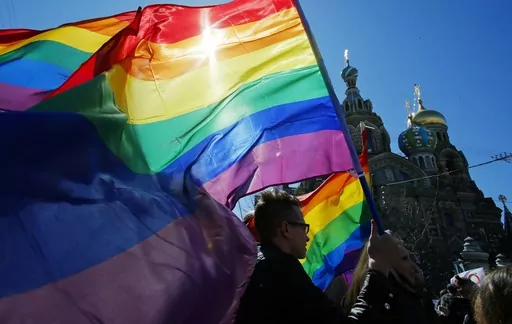Gay rights activists carry rainbow flags as they march during a May Day rally in St. Petersburg, Russia, Wednesday, May 1, 2013. Russia’s Supreme Court on Thursday, Nov. 30, 2023, effectively outlawed LGBTQ+ activism, in the most drastic step against advocates of gay, lesbian and transgender rights in the increasingly conservative country. (AP Photo, File)