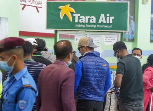 A signage of Tara Airlines is seen behind as a team of climbers prepare to leave for rescue operations from the Tribhuvan International Airport in Kathmandu, Nepal, Sunday, May 29, 2022. A small airplane with 22 people on board flying on a popular tourist route was missing in Nepal’s mountains on Sunday, an official said. The Tara Airlines plane, which was on a 15-minute scheduled flight to the mountain town of Jomsom, took off from the resort town of Pokhara, 200 kilometers (125 miles) east o