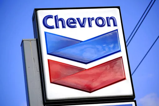 A Chevron sign is displayed outside one of the company's gas stations in Bradenton, Fla., Feb. 22, 2022. The Biden administration is easing some oil sanctions on Venezuela in an effort to support newly restarted negotiations between the Venezuelan government and its opposition. The Treasury Department is allowing Chevron to resume “limited” energy production in Venezuela after years of sanctions that have dramatically curtailed oil and gas profits that have flowed to President Nicolás Madur