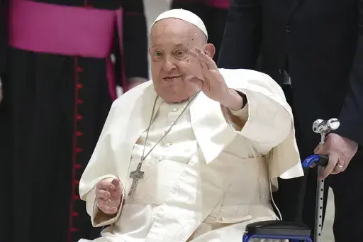 Pope Francis waves as he arrives for his weekly general audience in the Paul VI Hall, at the Vatican, Wednesday, Feb. 12, 2025. (AP Photo/Alessandra Tarantino, File)