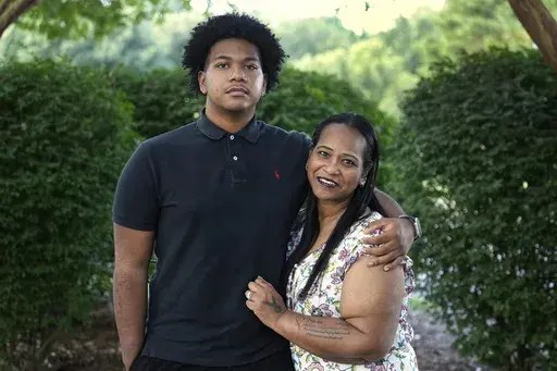 Robin Alderman, right, and her son, Camden Alderman, 21, pose for a portrait near their home in Greensboro, N.C., Wednesday, June 12, 2024. Camden, 21, was diagnosed as a baby with a rare disease called Wiskott-Aldrich syndrome, which is caused by a mutated gene on the X chromosome. It primarily affects boys – up to 10 out of every million — and can cause frequent infections, eczema and excessive bleeding. (AP Photo/Chuck Burton)