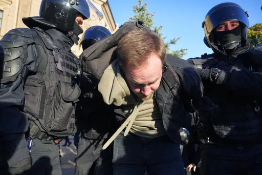 Russian policemen detain a demonstrator protesting against mobilization in St. Petersburg, Russia, Saturday, Sept. 24, 2022. (AP Photo)