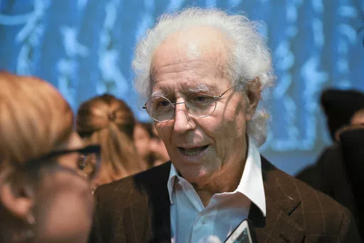 Luciano Benetton speaks to guests after the Benetton women's Fall-Winter 2019-2020 collection, that was presented in Milan, Italy, on Feb.19, 2019. Benetton, a co-founder of the apparel brand, announced he was stepping down as chairman in an interview Saturday May 25, 2024 with the Milan daily Corriere della Sera where he blamed current management for losses of 100 million euros ($108.5 million) that he discovered last year. (AP Photo/Luca Bruno, File)