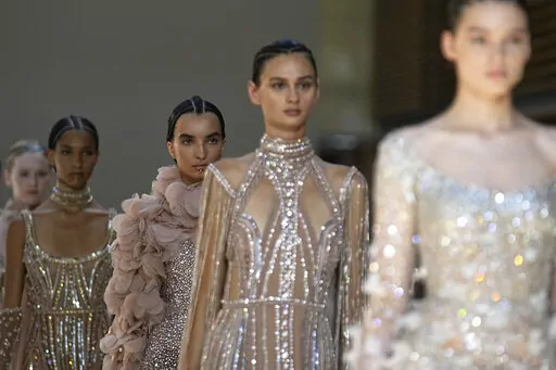 Models wear creations as part of Elie Saab's Haute Couture Fall/Winter 2022-2023 fashion collection presented Wednesday, July 6, 2022 in Paris. (AP Photo/Michel Euler)