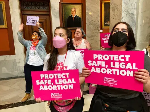 Abortion-rights supporters chant their objections at the Kentucky Capitol on Wednesday, April 13, 2022, in Frankfort, Ky., as Kentucky lawmakers debate overriding the governor's veto of an abortion measure.   Frustration is building among abortion rights groups in Kentucky, where a restrictive new law has thrown the state’s only two remaining clinics into limbo. For women seeking abortions, it means traveling elsewhere or waiting for a judge to rule on requests to block the law.  AP Photo/Bruc