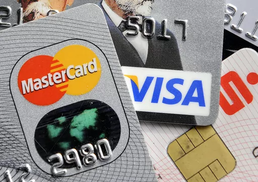 This Nov. 18, 2009, file photo, shows credit and bank cards with electronic chips in Gelsenkirchen, Germany. Are you getting the most out of your credit cards? It’s easy to keep using the same plastic, but fees and benefits change all the time. Investigate all the benefits each card offers, since you may have forgotten some and some may have been added. Then total up other monetary benefits — such as cash back — that you gained over the past year and compare that to the annual fee. (AP Pho