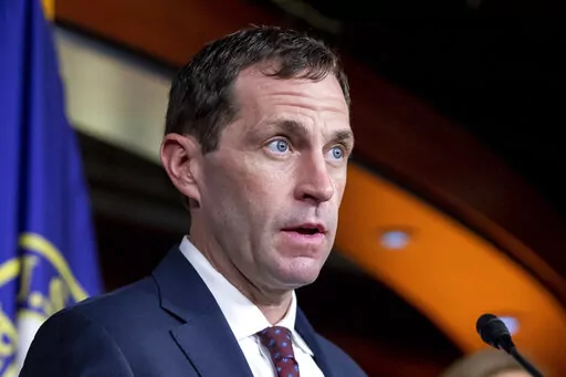 FILE - Rep. Jason Crow, D-Colo., speaks to members of the media during a news conference on Capitol Hill in Washington, Aug. 24, 2021. Crow announced he has tested positive for COVID-19. (AP Photo/Amanda Andrade-Rhoades, File)
