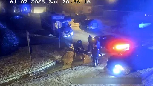 In this image from video released and partially redacted by the city of Memphis, Tenn., Tyre Nichols lies on the ground during a brutal attack by Memphis Police officers, Jan. 7, 2023, in Memphis. Documents released Thursday, March 2, showed that two Memphis Fire Department emergency medical technicians who were fired and had their licenses suspended for failing to give aid to Nichols for 19 minutes while he struggled with injuries from being brutally beaten by police did not check his vital sig