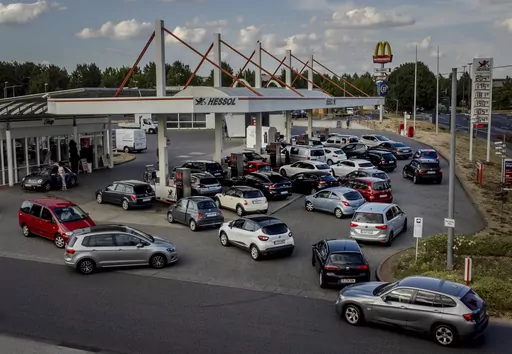 People queue with their cars at a gas station in Frankfurt, Germany, on Aug. 31, 2022, the last day when the government's fuel prize discount is in effect. Major oil-producing countries led by Saudi Arabia and Russia have said they're throttling back supplies of crude — again. And this time, the decision to cut back was a surprise that is underlining worries about where the global economy might be headed. (AP Photo/Michael Probst, File)