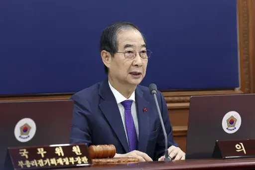South Korea's Prime Minister Han Duck-soo, who became the country's acting leader after President Yoon Suk Yeol's impeachment, speaks during a cabinet meeting at the government complex in Seoul, South Korea, Tuesday, Dec. 17, 2024. (Hong Hae-in/Yonhap via AP)