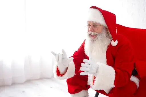 This photo shows Charles Graves dressed as Santa Claus in Austin, Texas on on Sept. 3, 2022. Graves is a rare Deaf Santa in his first year donning the red suit as a professional. (Michael J. Samaripa via AP)