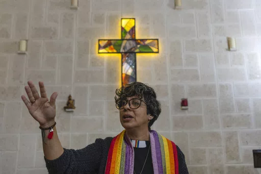 Rev. Elaine Saralegui, wearing a rainbow-colored clergy stole and her clerical collar, leads a service at the Metropolitan Community Church, an LGBTQ+ inclusive house of worship, in Matanzas, Cuba, Friday, Feb. 2, 2024. In recent years, the communist-run island barred anti-gay discrimination, and a 2022 government-backed “family law” — approved by popular vote — allowed same-sex couples the right to marry and adopt. (AP Photo/Ramon Espinosa) (AP Photo/Ramon Espinosa)