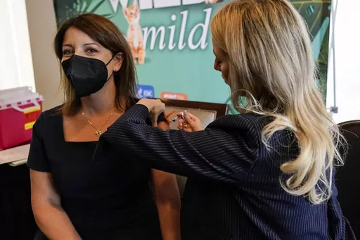 Dr. Mandy Cohen, director of the Centers for Disease Control and Prevention, receives a flu vaccine from Nurse Practitioner Whitney Goggans at the Atlanta Press Club, where Cohen spoke about health issues, Wednesday, Sept. 6, 2023, in Atlanta. Cohen says the U.S. is in “our strongest position yet” to avoid another chaotic respiratory season. “There will be a lot of virus this winter. That’s why we want to get ahead of it.” (AP Photo/Mike Stewart, File)