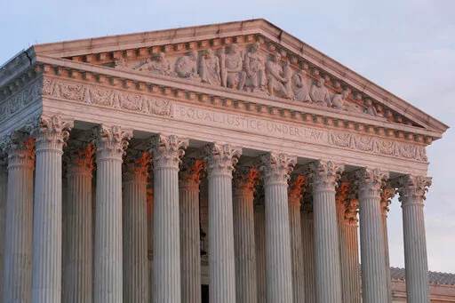 The setting sun illuminates the Supreme Court building on Capitol Hill in Washington, Jan. 10, 2023. The Supreme Court on Friday, Jan. 13, agreed to consider what employers must do to accommodate religious employees, among eight new cases it added. (AP Photo/Patrick Semansky, File)