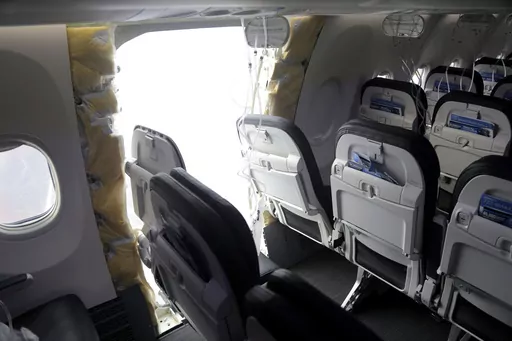 This photo released by the National Transportation Safety Board shows a gaping hole where the paneled-over door had been at the fuselage plug area of Alaska Airlines Flight 1282, Jan. 7, 2024, in Portland, Ore. The DOJ has launched a criminal investigation into the Boeing jetliner blowout that left a gaping hole on the Alaska Airlines plane this January, the Wall Street Journal reported Saturday, March 9. (National Transportation Safety Board via AP, File)