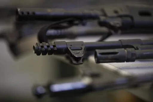 Illegally possessed firearms seized by authorities are displayed during a news conference Oct. 9, 2018, in Los Angeles. As Americans reel from repeated shootings, law enforcement officials and experts on extremism are taking increasing notice of the sprawling online space devoted to guns and gun rights: gun forums, tactical training videos, websites that sell unregistered gun kits and social media platforms where far-right gun owners swap practical tips with talk of dark plots to take their weap