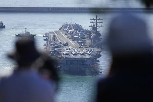 USS Ronald Reagan is escorted as it arrives in Busan, South Korea on Sept. 23, 2022. North Korea warned Saturday, Oct. 8, the U.S. redeployment of an aircraft carrier near the Korean Peninsula is causing a “considerably huge negative splash” in regional security, as it defended its recent missile tests as a “righteous reaction” to intimidating military drills between its rivals (AP Photo/Lee Jin-man)
