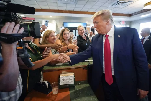 Former President Donald Trump greets supporters at Versailles restaurant on Tuesday, June 13, 2023, in Miami. Trump appeared in federal court Tuesday on dozens of felony charges accusing him of illegally hoarding classified documents and thwarting the Justice Department's efforts to get the records back. (AP Photo/Alex Brandon, File)