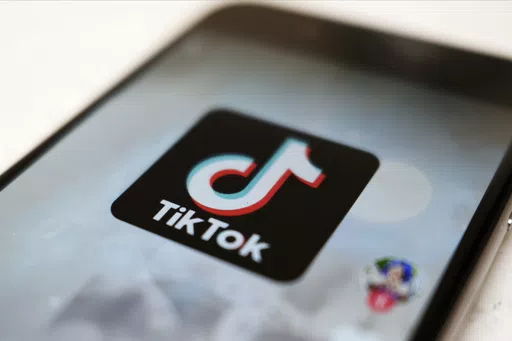 The TikTok logo is displayed on a smartphone screen in Tokyo on Sept. 28, 2020. TikTok says it's going to start automatically labeling content that's made by artificial intelligence when it's uploaded from certain platforms. TikTok says its efforts are an attempt to combat misinformation from being spread on its social media platform. The announcement came on ABC's “Good Morning America” on Thursday, May 9, 2024. (AP Photo/Kiichiro Sato, File)