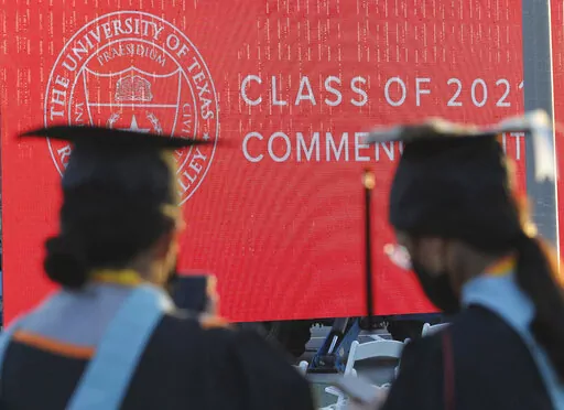 Graduates of the University of Texas Rio Grande Valley attend their commencement ceremony at the schools parking lot on Friday, May 7, 2021, in Edinburg, Texas.  Buy now, pay later financing options are increasingly being offered by for-profit credentialing schools and boot camps. The “learn now, pay later” concept is appealing, and students are already familiar with the name brand companies since buy now, pay later is ubiquitous within online retail.  (Delcia Lopez/The Monitor via AP, File)