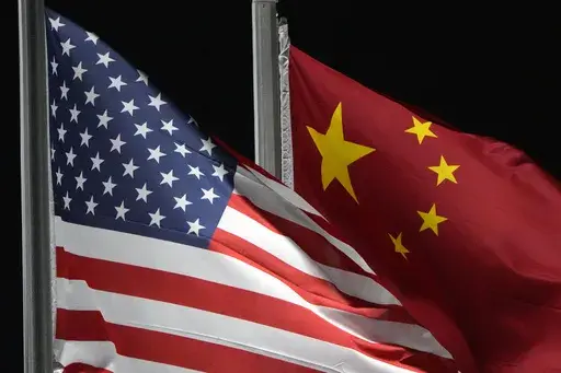 The American and Chinese flags wave at Genting Snow Park, Feb. 2, 2022, in Zhangjiakou, China. (AP Photo/Kiichiro Sato, File)