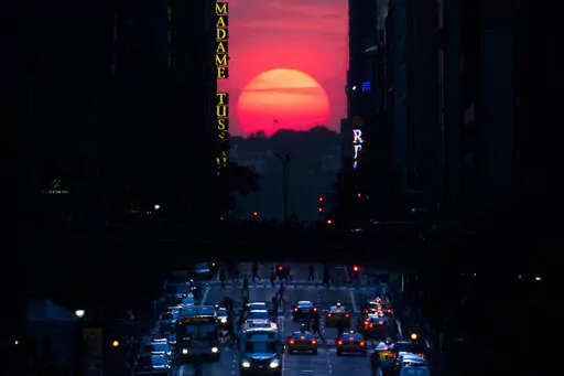 The sun sets along 42nd Street in Manhattan during an annual phenomenon known as "Manhattanhenge," when the sun aligns perfectly with the city's transit grid, Wednesday, May 29, 2013, in New York. There's still time to catch Manhattanhenge, when the setting sun aligns with the Manhattan street grid and bathes the urban canyons in a rosy glow. The last two Manhattanhenge sunsets of 2022 are Monday and Tuesday, July 11-12. (AP Photo/John Minchillo, File)