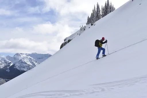 Doug Chabot with the Gallatin National Forest Avalanche Center ascends Henderson Mountain in the Beartooth Mountains, Jan 29, 2024 near Cooke City, Mont. Chabot was climbing to the site of a recent avalanche. (AP Photo/Matthew Brown)