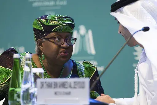 World Trade Organization Director-General Ngozi Okonjo-Iweala talks to Emirati Minister of State for Foreign Trade Thani bin Ahmed al-Zeyoudi on stage at a WTO summit in Abu Dhabi, United Arab Emirates, Monday, Feb. 26, 2024. The World Trade Organization opened its biennial meeting Monday in the United Arab Emirates as the bloc faces pressure from the United States and other nations ahead of a year of consequential elections around the globe. (AP Photo/Jon Gambrell)