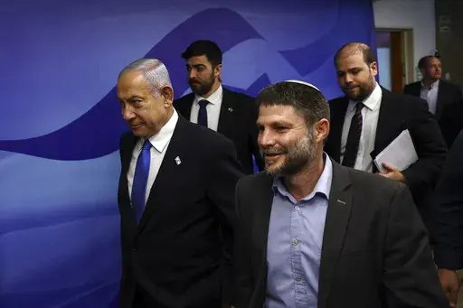 Israeli Prime Minister Benjamin Netanyahu, left, and Finance Minister Bezalel Smotrich, right, arrive to attend a cabinet meeting at the Prime Minister's office in Jerusalem, Feb. 23, 2023. The ultranationalist member of Israel's ruling coalition says there's no such thing as a Palestinian people. Finance Minister Smotrich's remark Sunday, March 19, came within hours of efforts to calm tensions between Israel and the Palestinians over the country's contentious plan to overhaul the judiciary. (Ro