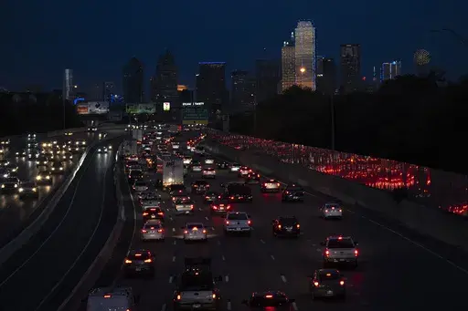 Vehicles travel along Interstate-30 with the Dallas skyline seen in the distance, Nov. 27, 2023. On Thursday, June 27, 2024, the U.S. Census Bureau released population estimates which showed Texas leading all other states in new Hispanic, Asian and Black residents added last year. (AP Photo/Julio Cortez, File)