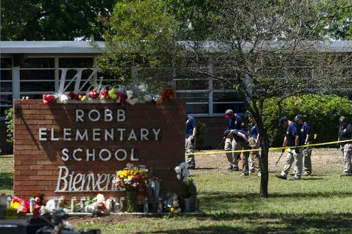 Investigators search for evidences outside Robb Elementary School in Uvalde, Texas, May 25, 2022, after an 18-year-old gunman killed 19 students and two teachers. Uvalde Consolidated Independent School District Police Chief Pete Arredondo, who served as on-site commander during the shooting, said that he's talking daily with investigators, contradicting claims from state law enforcement that he has stopped cooperating. (AP Photo/Jae C. Hong, File)